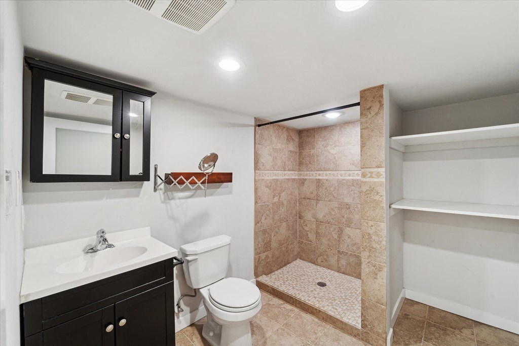 a bathroom with a shower toilet and sink