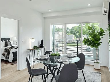 A dining room with a glass table and chairs.