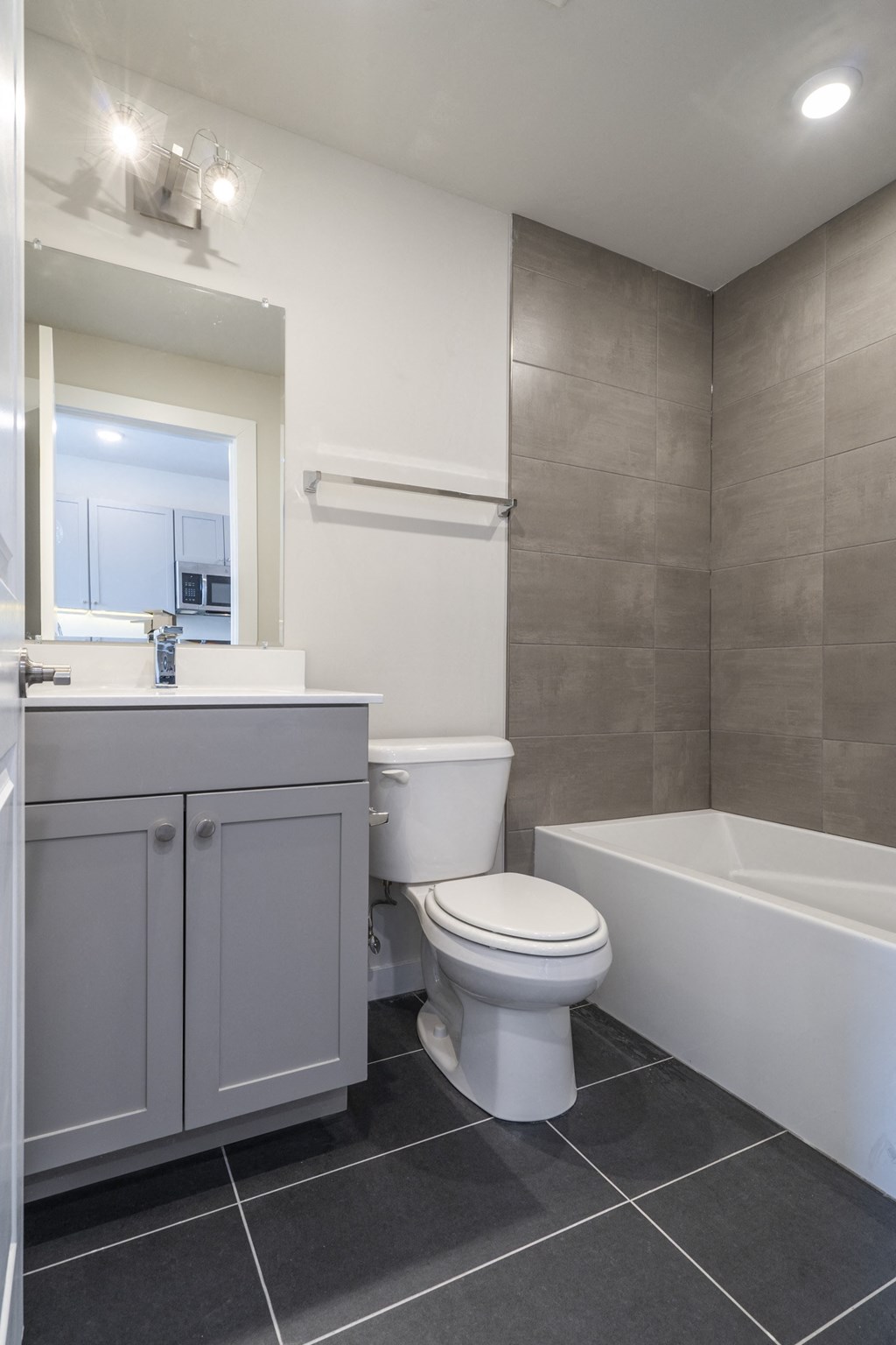 a bathroom with a toilet and a tub and a sink
