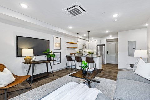 a living room with a couch and a table and a kitchen