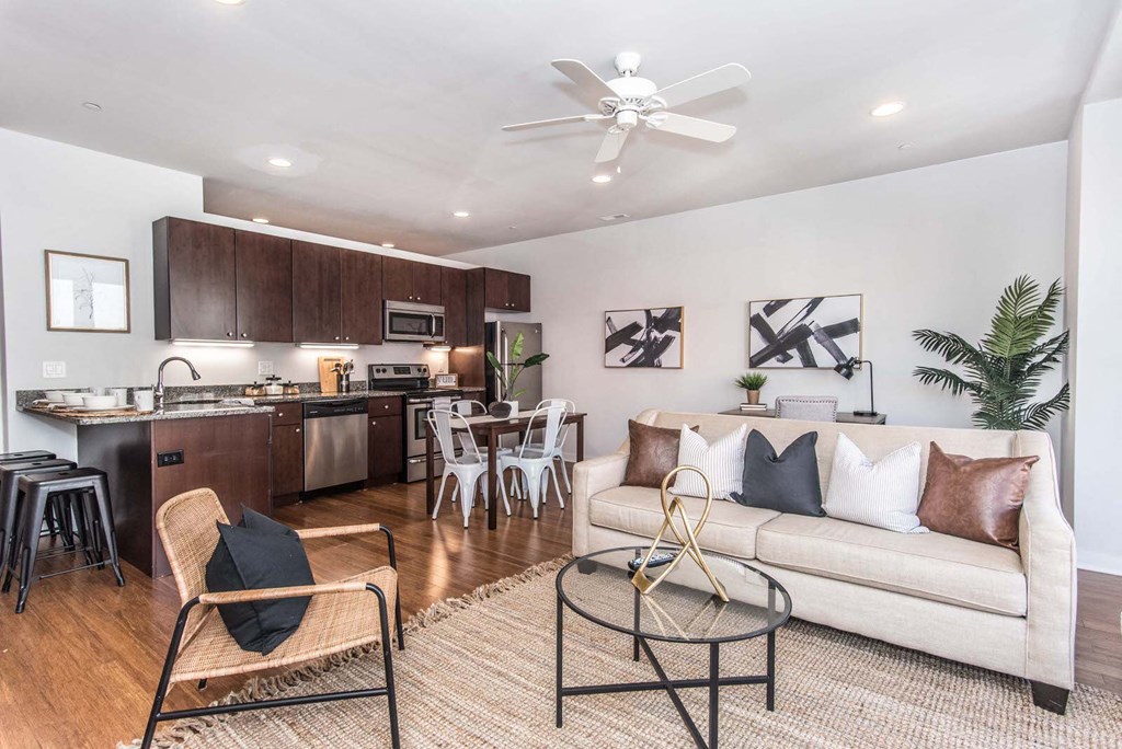 a living room and kitchen with a couch and a table