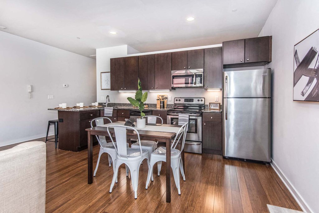 a kitchen with stainless steel appliances and a wooden table