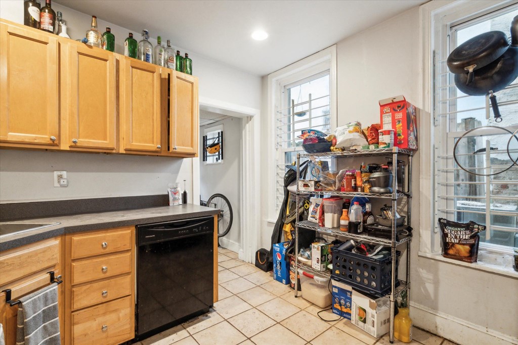 a kitchen with a sink and a lot of wires and cabinets
