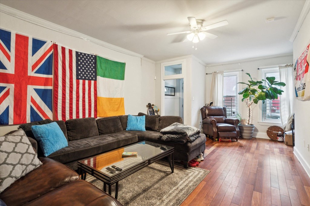 a living room with leather furniture and an flag on the wall