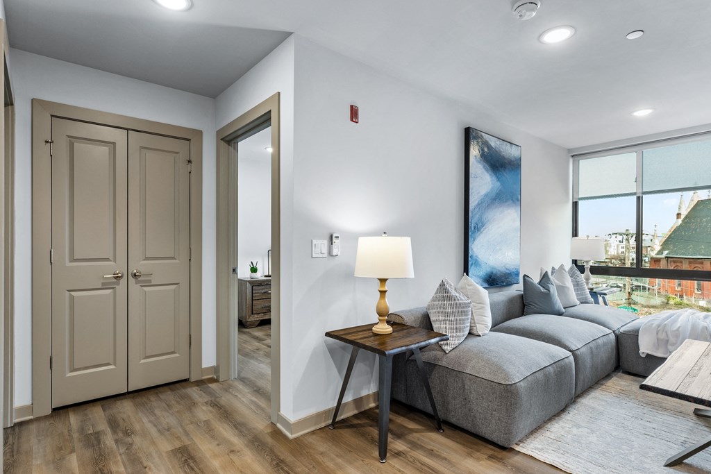 a living room with a couch and a door to a bedroom