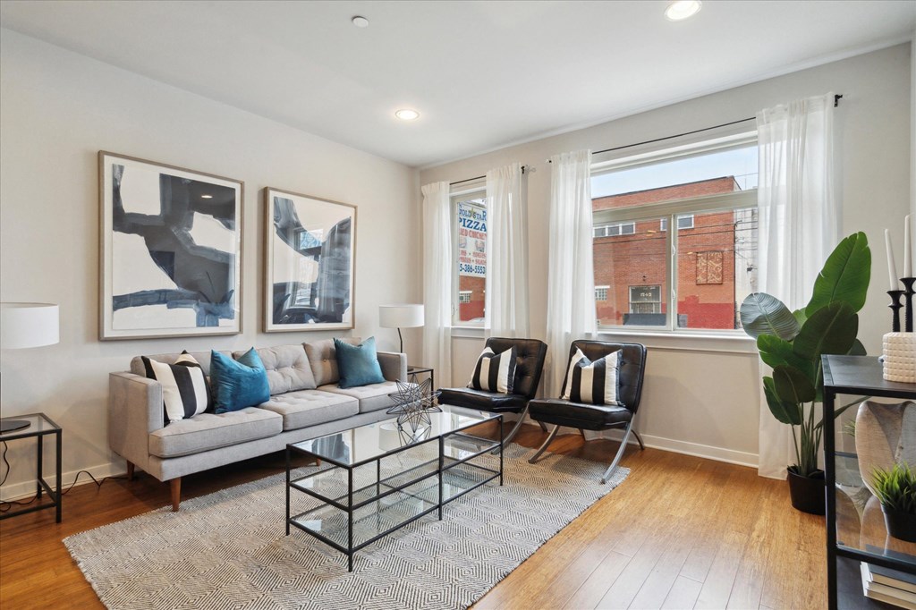 a living room with a couch and a glass coffee table