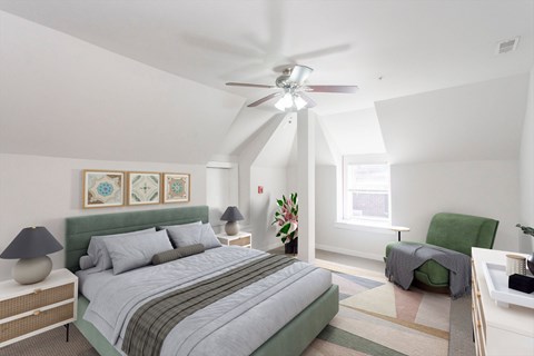 A bedroom with a bed, a chair, and a ceiling fan.