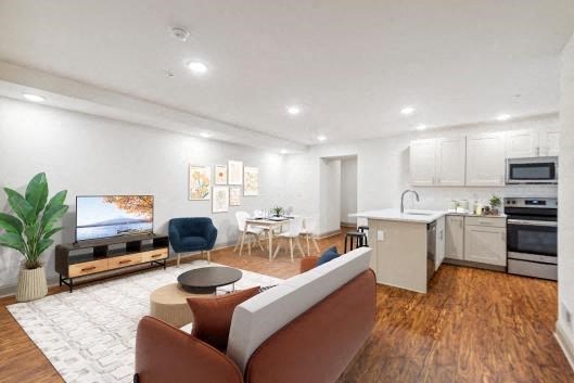 a living room filled with furniture and a flat screen tv