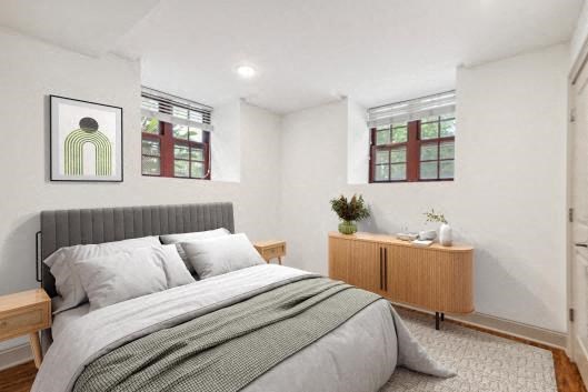 a bedroom with a bed and two windows