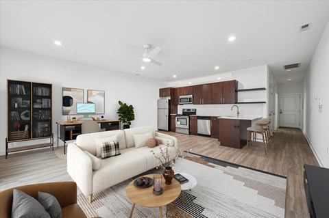 A modern living room with a white sofa and a coffee table.