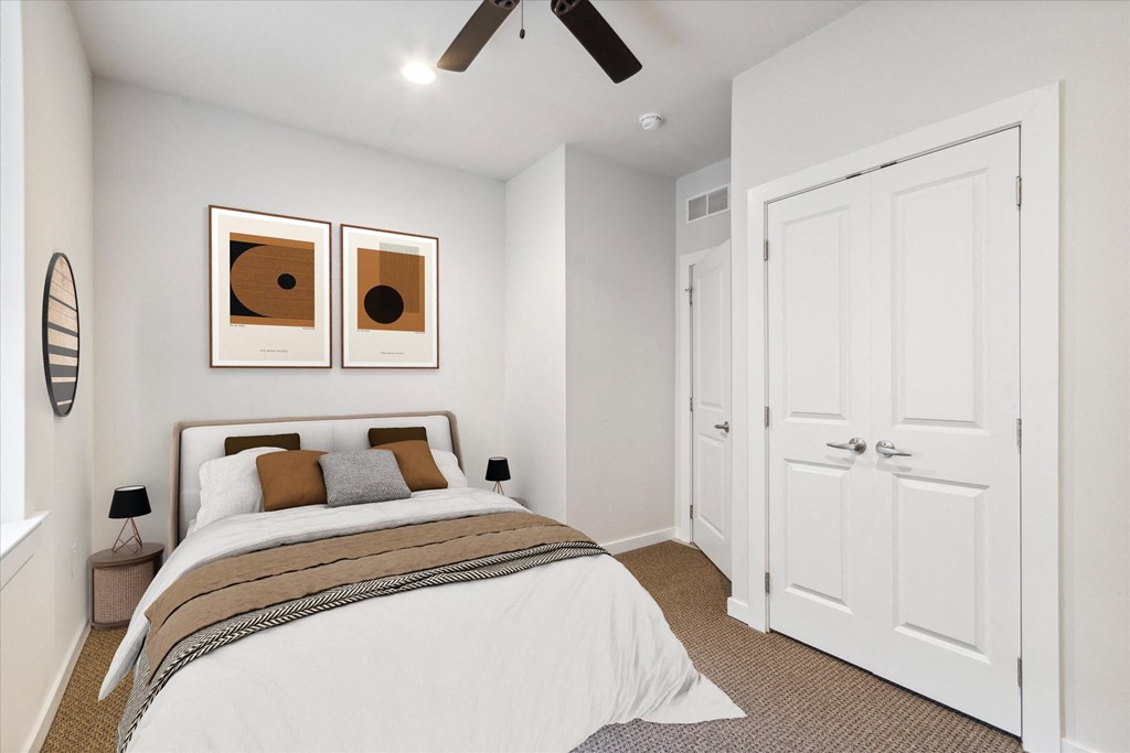 a bedroom with a bed and a ceiling fan