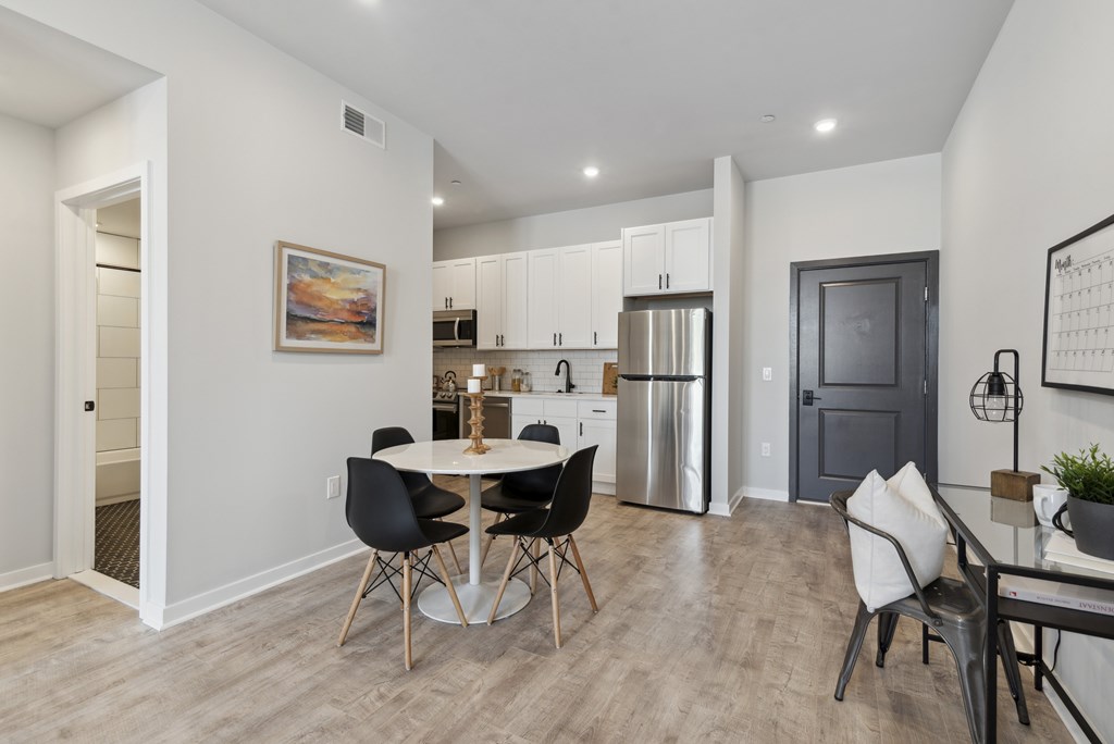A modern kitchen with a dining table and chairs.