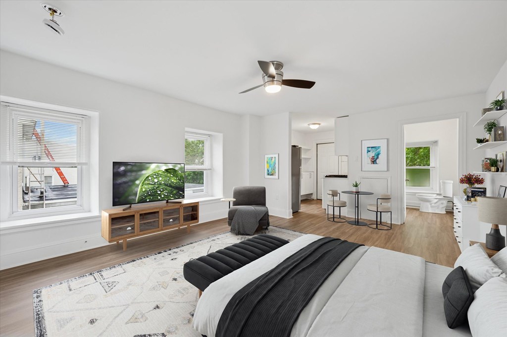 A modern bedroom with a large bed and a flat screen TV.