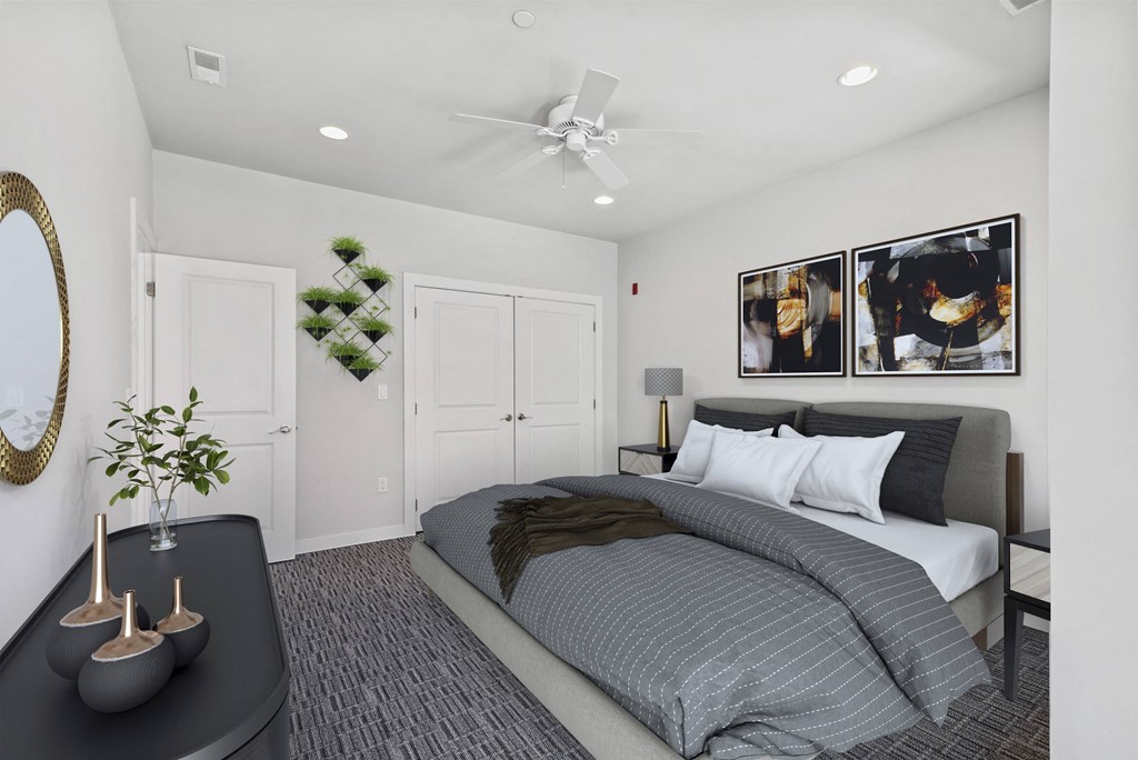 a bedroom with a bed and a ceiling fan