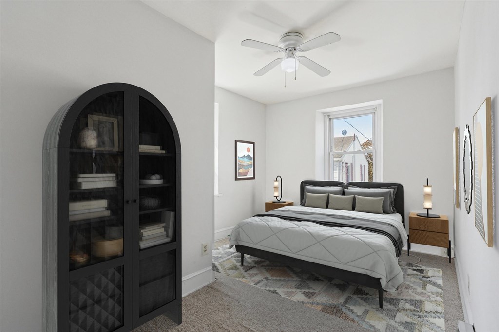 A bedroom with a large bed and a dresser with a mirror.