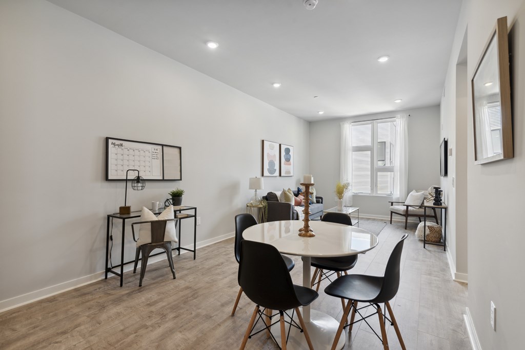 A dining room with a table and chairs.