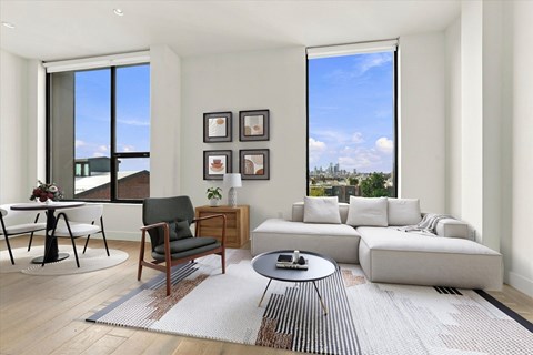 A modern living room with a large window and a view of the city.