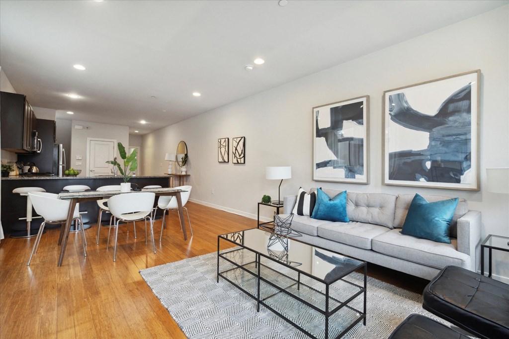 a living room with a couch and a glass coffee table
