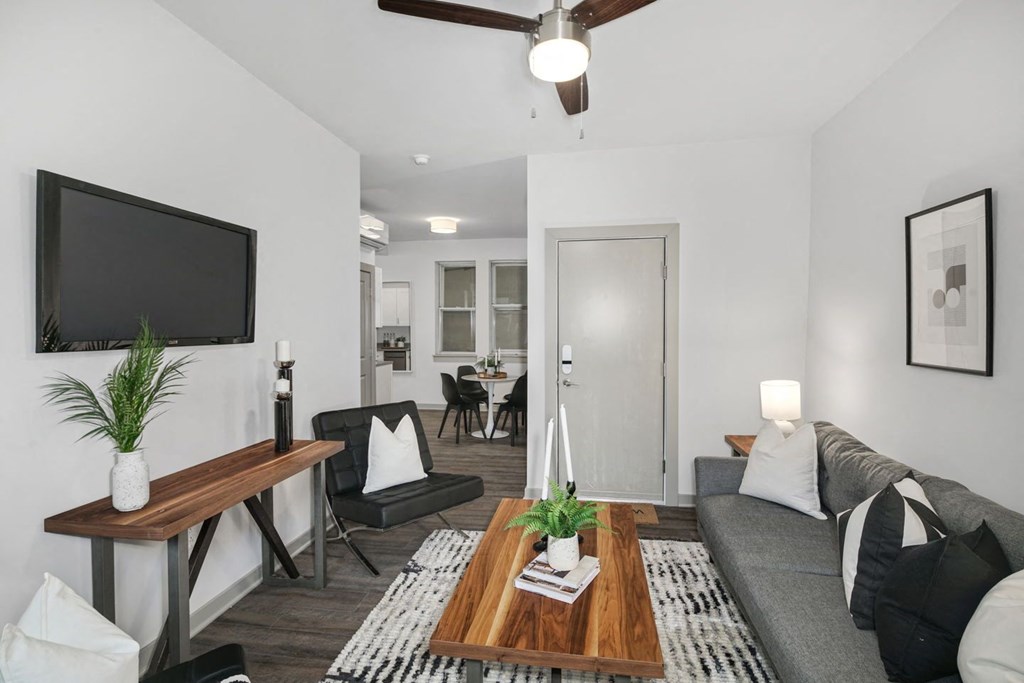 a living room with a grey couch and a wooden coffee table