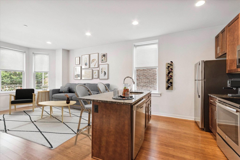 a kitchen with an island and a living room with a couch