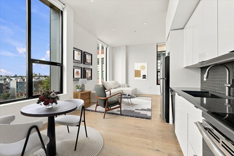 A modern kitchen with a dining table and chairs.