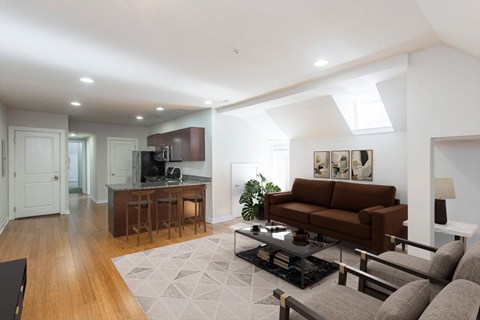 A modern living room with a brown couch and a black coffee table.