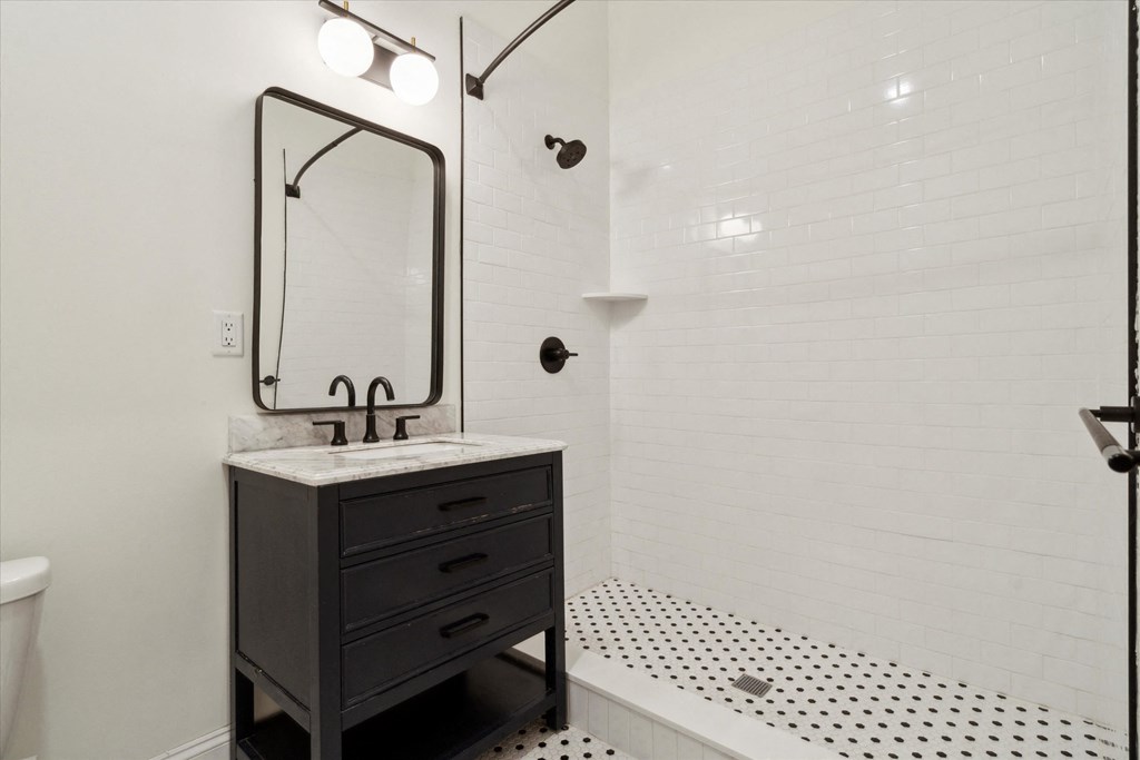 a bathroom with a sink and a mirror and a shower