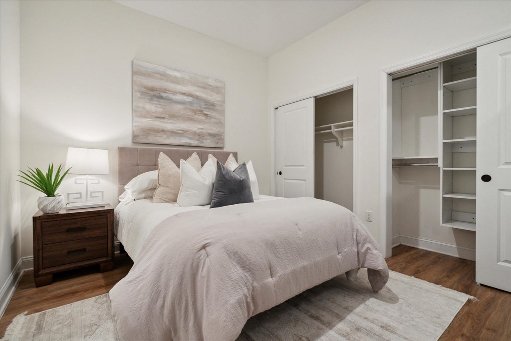 a bedroom with a large bed and a closet