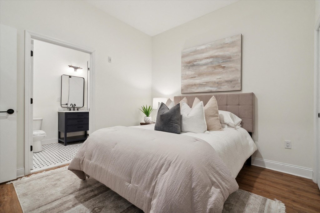 a bedroom with a large bed and a bathroom