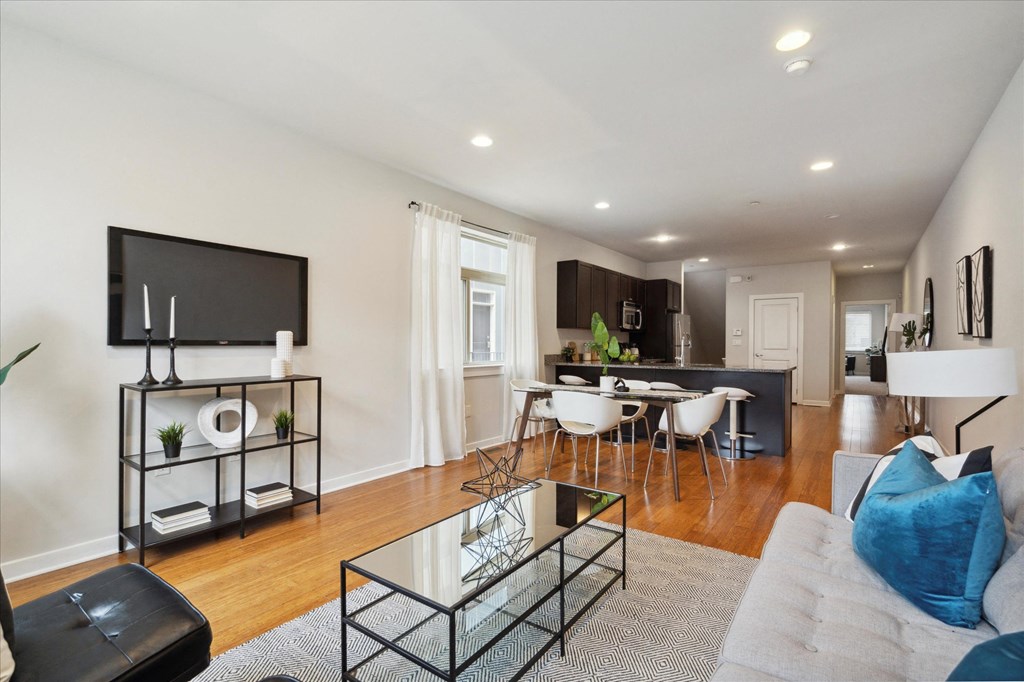 a living room with a couch and a table with chairs