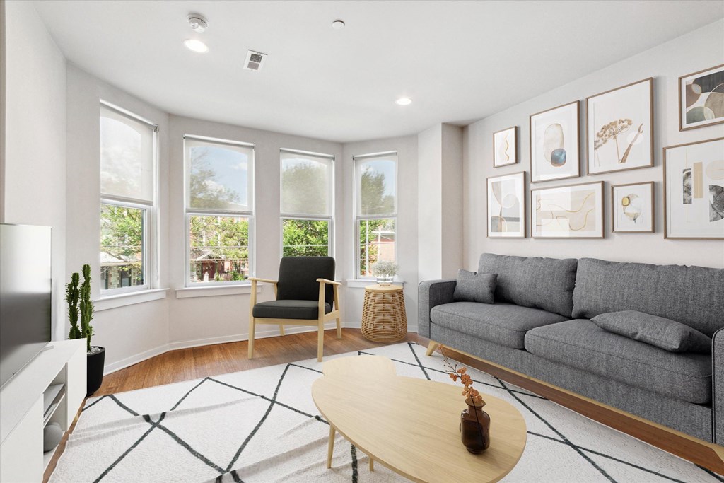a living room with a gray couch and a coffee table
