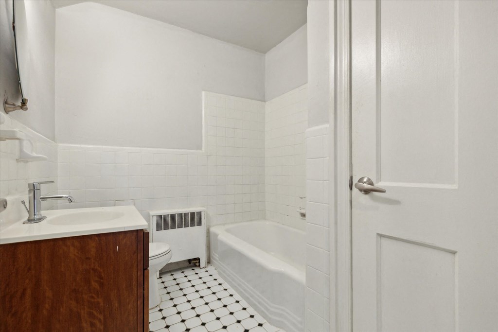 a bathroom with a sink and a toilet and a bath tub