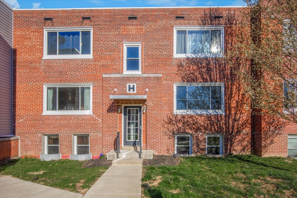 a brick building with a sidewalk in front of it