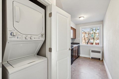a laundry room with a washer and dryer and a window
