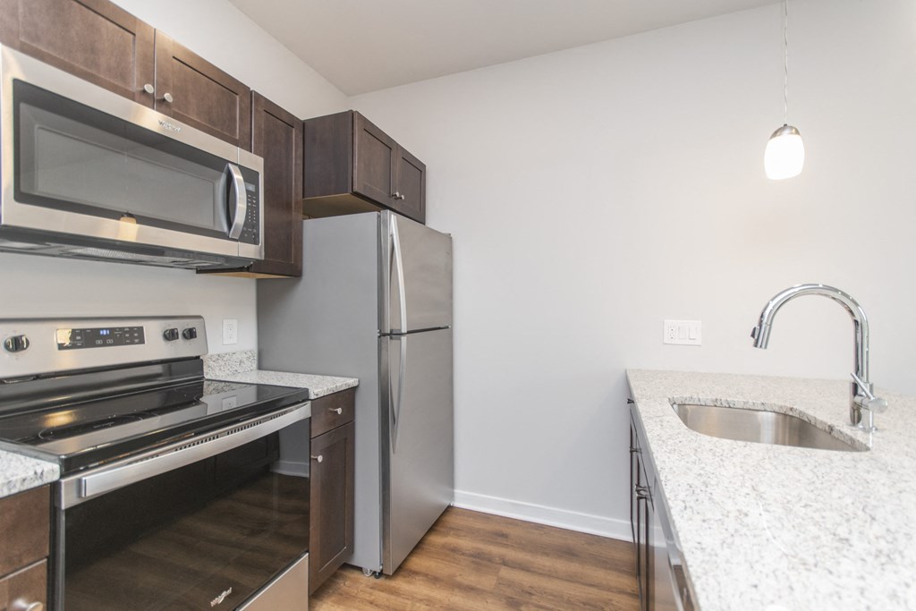 a kitchen with granite counter tops and stainless steel appliances and