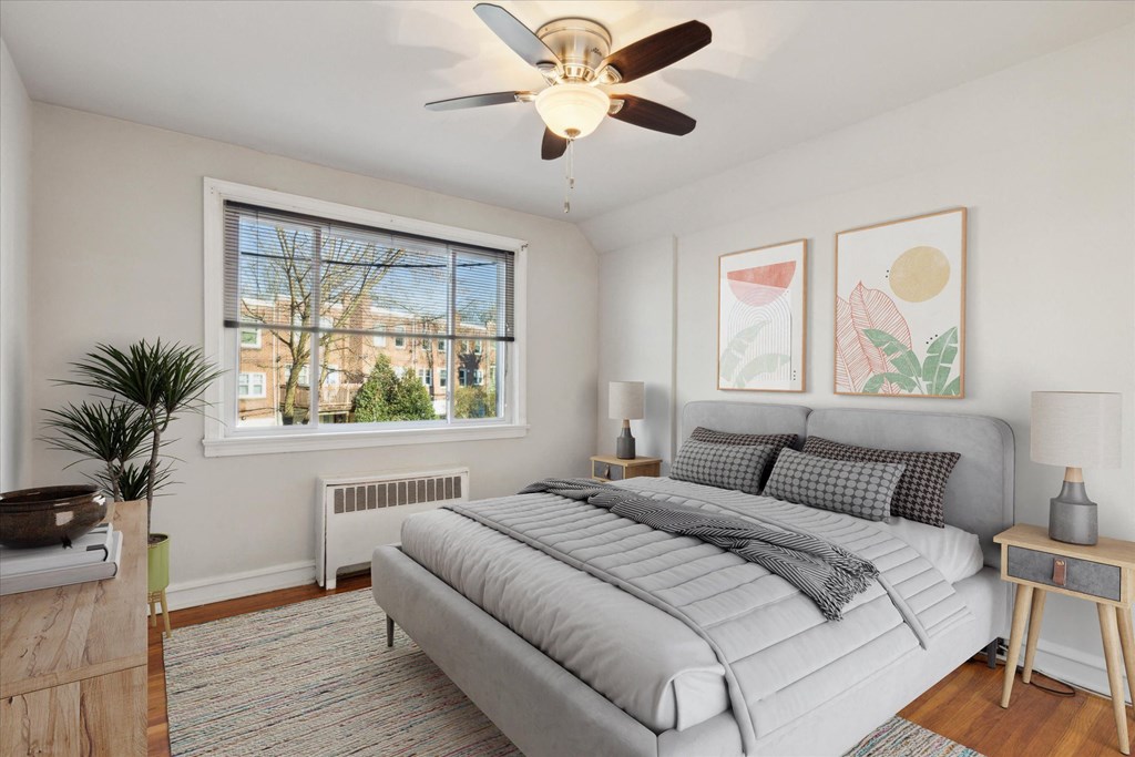 a bedroom with a bed and a ceiling fan