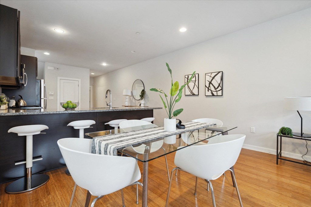 a dining room with a glass table and white chairs