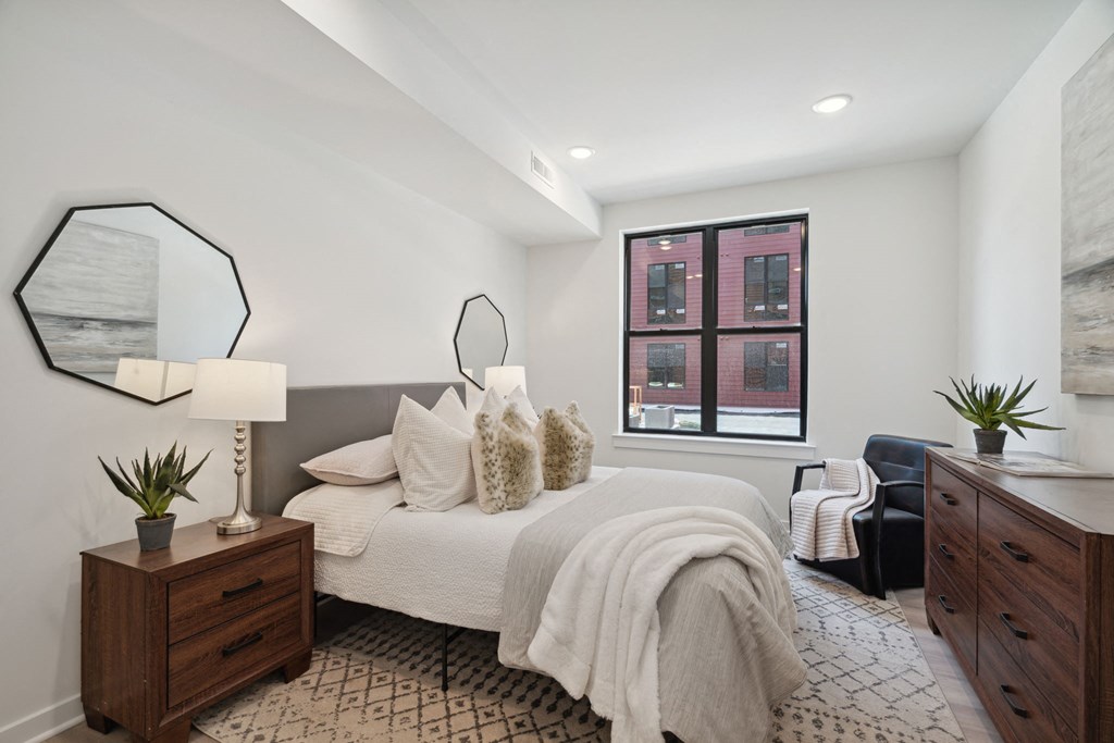 a bedroom with a large bed and a large window a bedroom with a large bed and a large window at The Anchorage on Kelly, East Falls