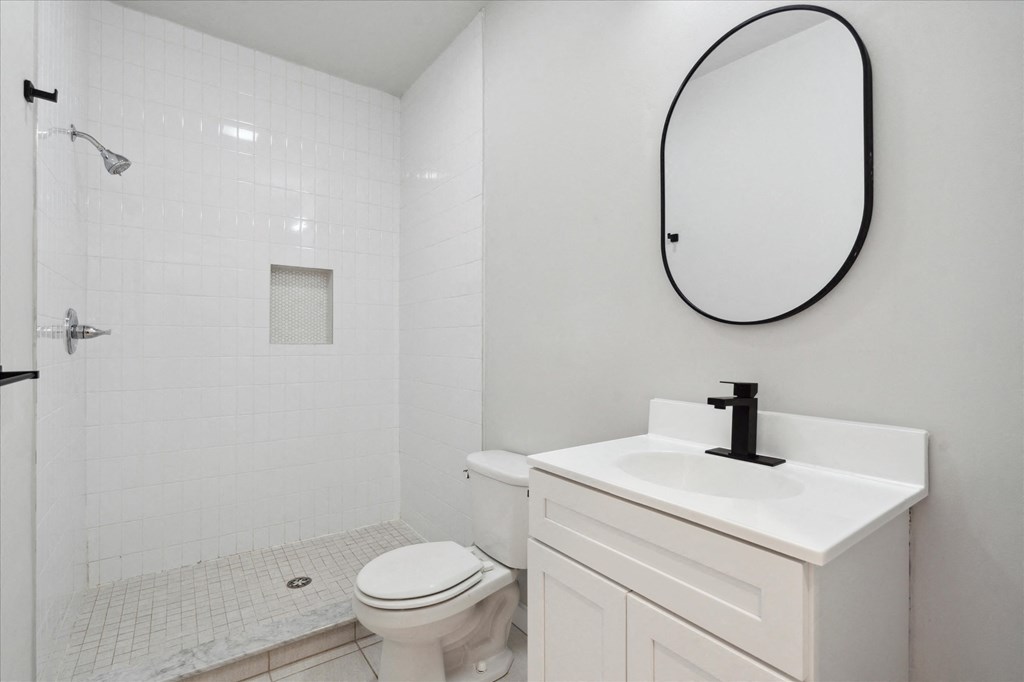 a bathroom with a sink toilet and a mirror