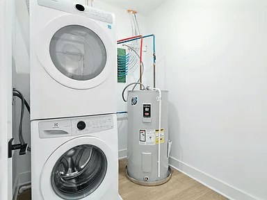 A white washing machine and dryer in a small laundry room.