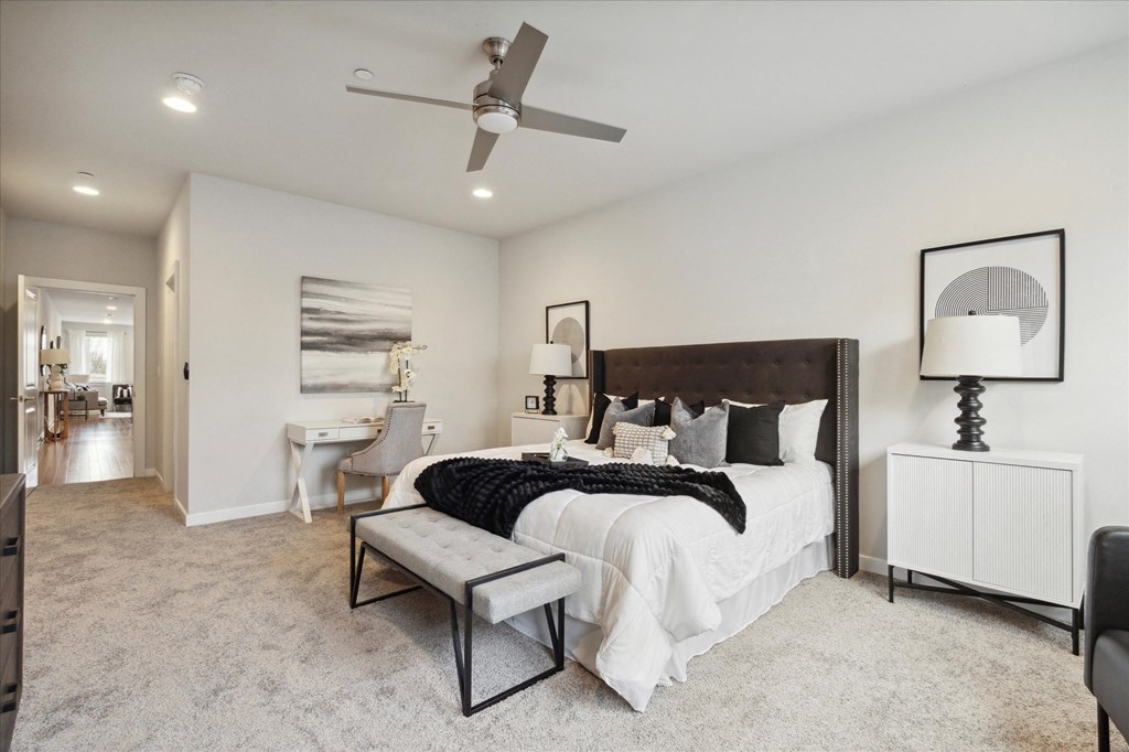a bedroom with a bed and a ceiling fan