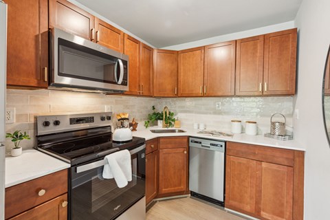 A kitchen with wooden cabinets and a black oven.