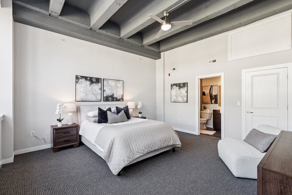 A bedroom with a large bed and a couch.