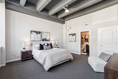A bedroom with a large bed and a couch.