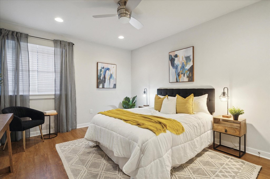 a bedroom with a large white bed and a yellow blanket