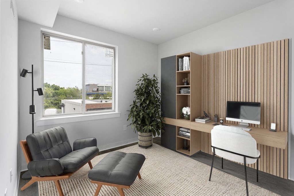 an image of a living room with a desk and a window