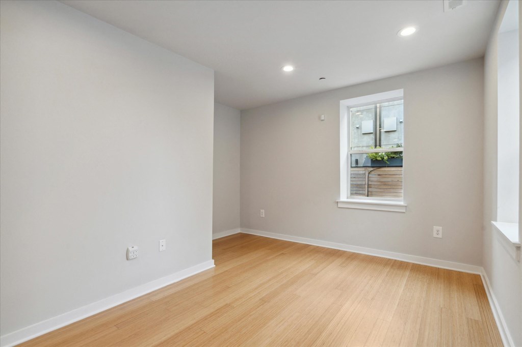 a living room with wood floors and a window