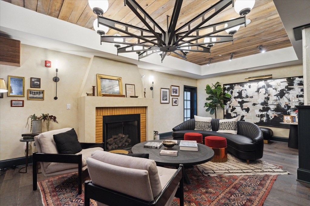 The lounge at Harbisons Dairy with couches and chairs, and a fireplace.