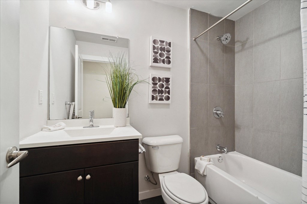 a bathroom with a toilet and a sink and a bath tub