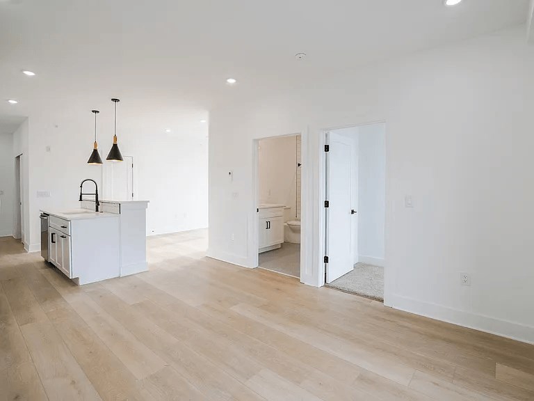 A kitchen with a white cabinet and a white fridge is shown.